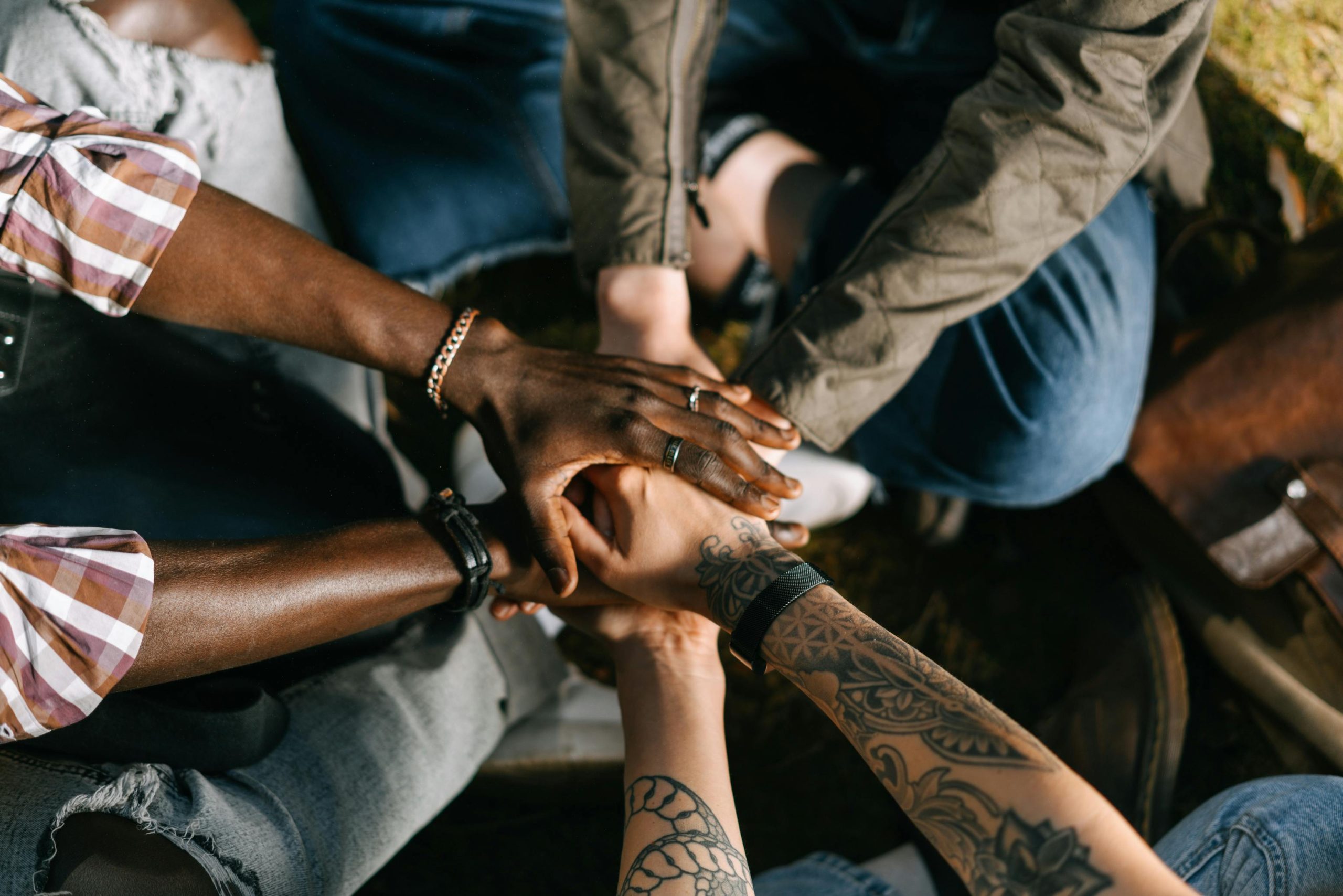 People with their hands together technology-facilitated gender-based violence