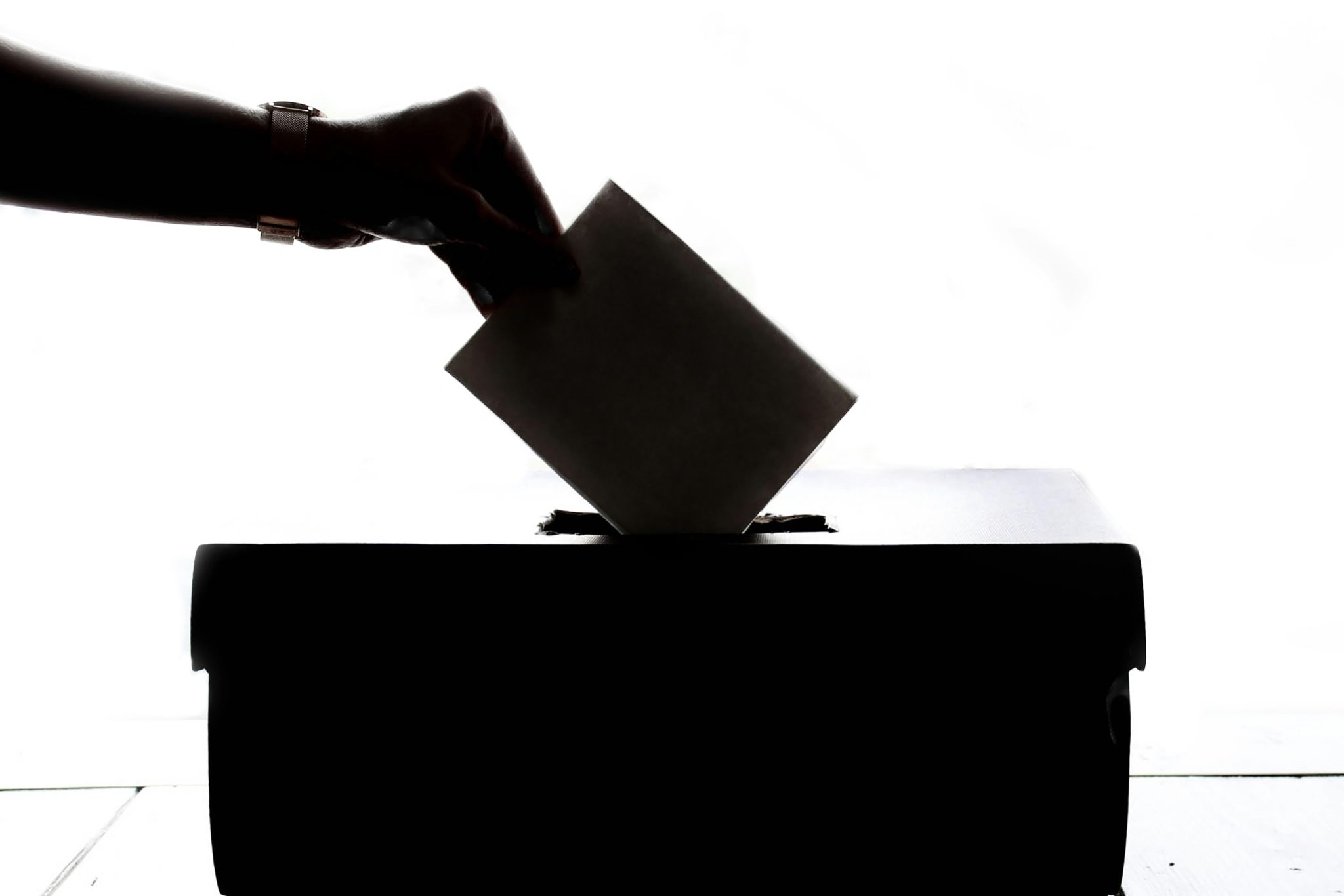 shadow of an arm casting a vote into a box Romanian Presidential elections