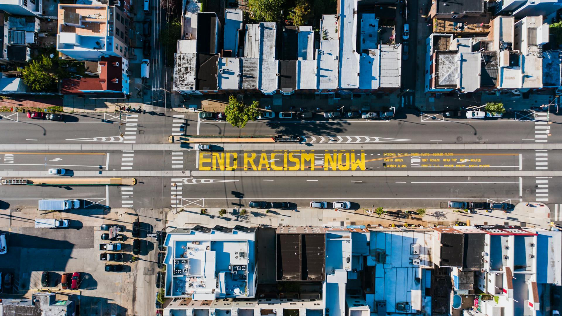 City road with bright END RACISM NOW inscription Just Access mental health